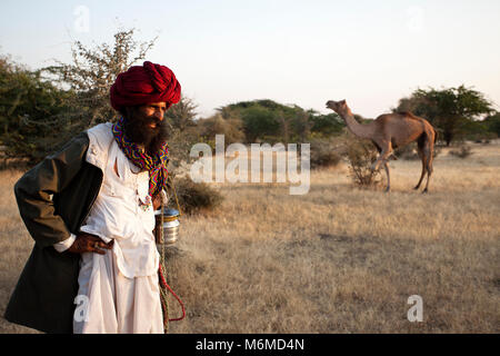 Rabari man with camel in the background Stock Photo