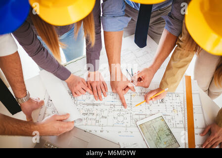 Young architect team discussing construction plans and planning what to change to be better. Top view. Stock Photo