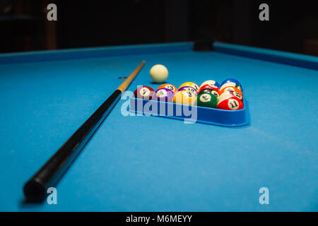 Billiards balls and cue on billiards table Stock Photo