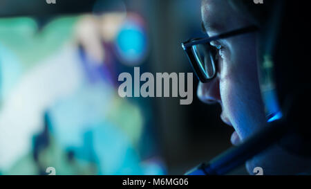 Close-up Shot of Professional Gamer Plays in MMORPG/ Strategy Video Game on His Computer. He's Participating in Online Cyber Games Tournament Stock Photo