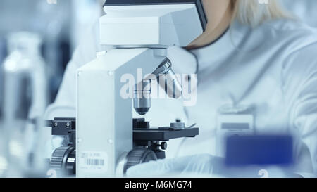 Close-up Shot of Scientist Using Microscope in Laboratory. Stock Photo