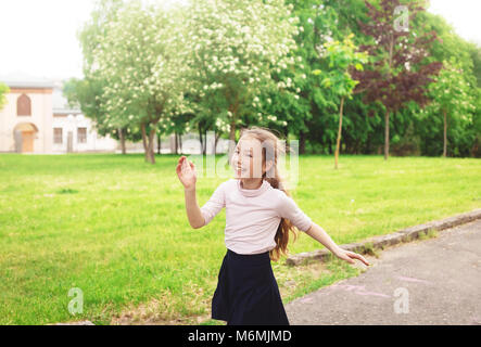 Happy child girl running on meadow in summer day Stock Photo