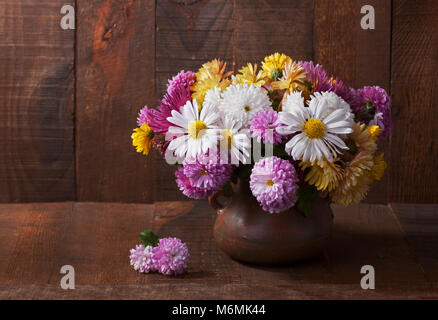 Still life with colourful chrysanthemums bunch  on old wooden table Stock Photo