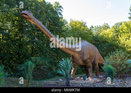 Brachiosaurus dinosaur model in the wild close up in summer forest ...