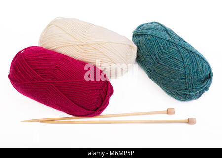 Balls of yarn and wooden knitting needles on white. Stock Photo