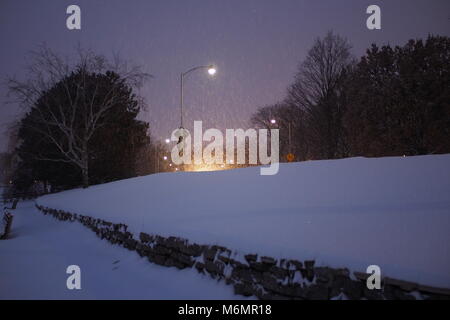 Car headlights and street lamps highlight the falling snow, Queen Elizabeth Drive at Dow's Lake, Ottawa, Ontario, Canada. Stock Photo