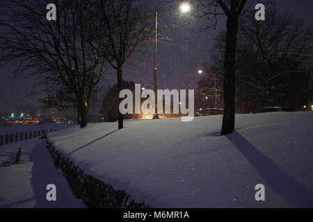 Car headlights and street lamps highlight the falling snow, Queen Elizabeth Drive at Dow's Lake, Ottawa, Ontario, Canada. Stock Photo