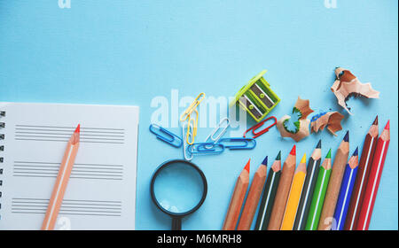 Different school or office supplies on a blue background. Education or business concept. Flat lay. Stock Photo