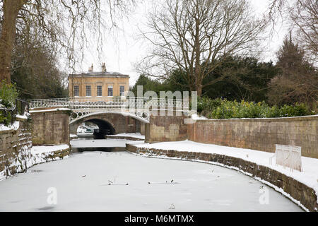 Wintry view of the Kennet and Avon Canal in Sydney Gardens, Bath, England during the big freeze at the beginning of March 2018. Stock Photo