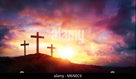 Crucifixion Of Jesus Christ At Sunrise - Three Crosses On Hill Stock Photo