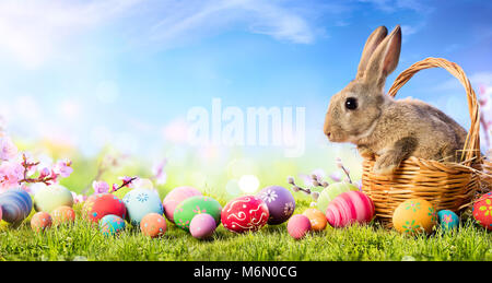 Little Bunny In Basket With Decorated Eggs - Easter Card Stock Photo