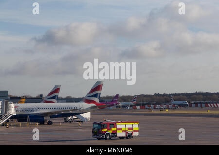 A fire engine in front of British Airways airliners at Gatwick Airport, London, UK. Stock Photo