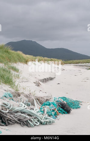 Fishing ropes and nets discarded and entangled in the beach and sand dunes on Howmore beach, South Uist, Outer Hebrides, Scotland, UK Stock Photo