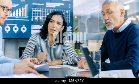 Group of Smart and Respectable Business People Work on a Problem Solving in the Meeting Room. Diverse Group of Mixed Ethnicity and Gender Explore Stock Photo