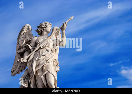 Angel holding the Holy Lance of Longinus (with beautiful sky and copy space). A 17th century baroque masterpiece at the top of Sant'Angelo Bridge in t Stock Photo