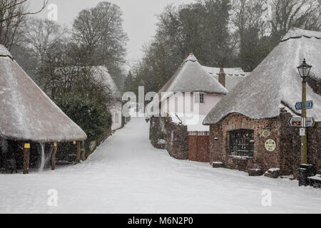 An unusual occurrence - the village of Cockington in South Devon, UK with a significant covering of snow from Storm Emma 2018 Stock Photo