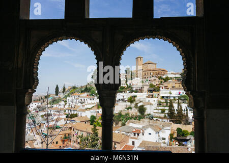 Granada, Andalusia, Spain. Unesco listed Albaicin district  and Church of San Cristobal framed by a Moorish window of the XV century Dar al-Horra pala Stock Photo