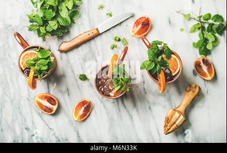 Blood orange Moscow mule alcohol cocktails, marble background Stock Photo