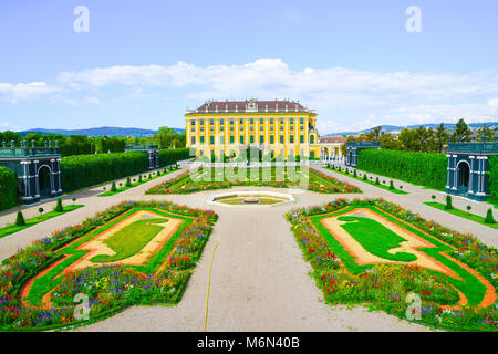 VIENNA,AUSTRIA - SEPTEMBER 4 2017; Formal gardens and paths to Baroque architectural detail of the Schonbrunn imperial palace, one of the major touris