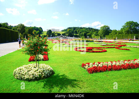 VIENNA,AUSTRIA - SEPTEMBER 4 2017; Landscape of formal gardens leading to distant Gliorriete baroque structure on distant hill in grounds of Schonbrun