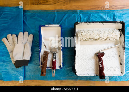 Rollers of different sizes,brush and gloves for painting the walls and ceiling. Painting tools Stock Photo