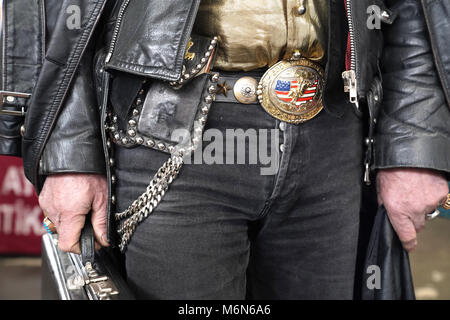 Modern cowboy with leather jacket and leather belt with buckle in the manner of american flag Stock Photo