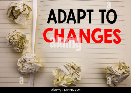 Handwritten text showing Adapt To Changes. Business concept writing for Adaptation New Future Written on notepad paper, white background with space an Stock Photo