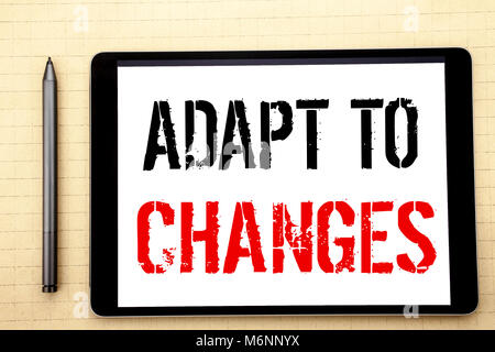 Handwritten text showing Adapt To Changes. Business concept writing for Adaptation New Future Written on tablet computer screen, white background offi Stock Photo