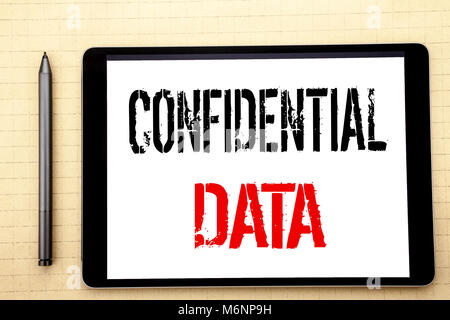 Handwritten text showing Confidential Data. Business concept writing for Secret Protection Written on tablet computer screen, white background office  Stock Photo