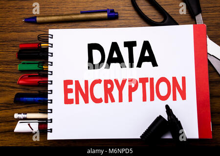 Handwritten text showing Data Encryption. Business concept for Information Security Written on notebook, wooden background office equipment like pens  Stock Photo