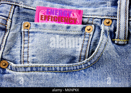 Handwritten text showing Energy Efficiency. Business concept writing for Electricity Ecology Written on condom pack in small pocket in the pants jeans Stock Photo