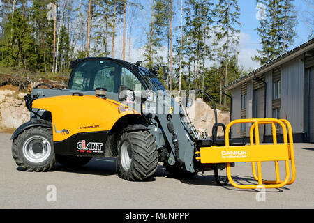 LIETO, FINLAND - MARCH 22, 2014: Giant 4548 Tendo telehandler with bale clamps displayed.  The advantages of telehandlers compared to forklift and fro Stock Photo