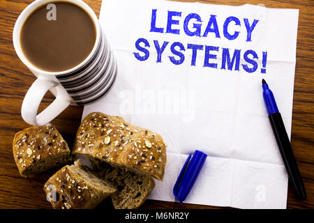 Handwritten text showing Legacy Systems. Business concept for Upgrade SOA Application written on tissue paper on wooden background with pen bread heal Stock Photo