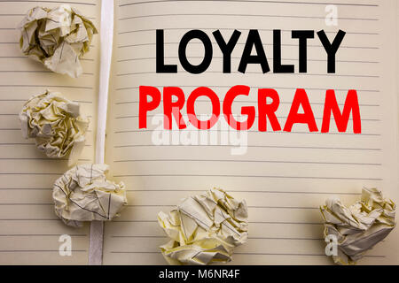 Handwritten text showing Loyalty Program. Business concept writing for Marketing Concept Written on notepad paper, white background with space and off Stock Photo