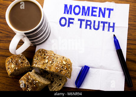 Handwritten text showing Moment Of Truth. Business concept for Hard Decision Pressure written on tissue paper on wooden background with pen bread heal Stock Photo