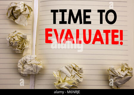 Handwritten text showing Time To Evaluate. Business concept writing for Assessment Evaluation Written on notepad paper, white background with space an Stock Photo