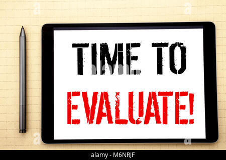 Handwritten text showing Time To Evaluate. Business concept writing for Assessment Evaluation Written on tablet computer screen, white background offi Stock Photo