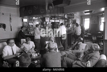 1970s, historical, men drinking and chatting in a proper British boozer of this era, the King's Arm Pub in Bagshot, Surrey, UK, a Watneys' pub. Stock Photo