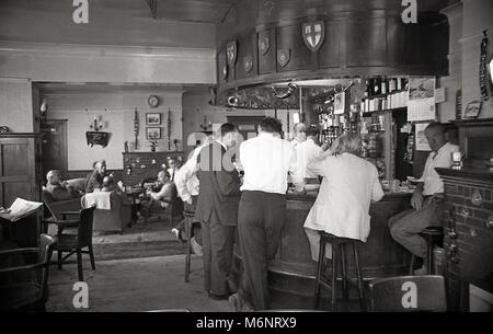 1970s, historical, men drinking and chatting in a proper British boozer of this era, the King's Arm Pub in Bagshot, Surrey, UK, a Watneys' pub. Stock Photo