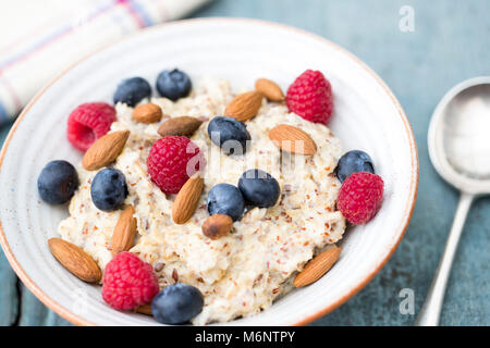 Bowl Of Porridge with Fruit And Nuts For Healthy Breakfast Stock Photo