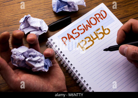 Word, writing Password 123456. Concept for Security Internet written on notebook notepad note paper on wooden background with folded paper meaning thi Stock Photo