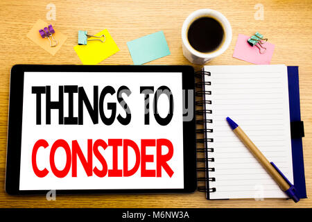 Word, writing Things To Consider. Business concept for Business Knowledge Written on tablet, wooden background with sticky note and pen Stock Photo