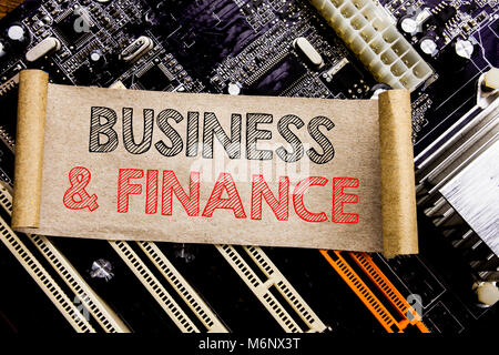 Writing text showing Business And Finance. Business concept for Company Strategy Written on sticky, computer main board background. Stock Photo