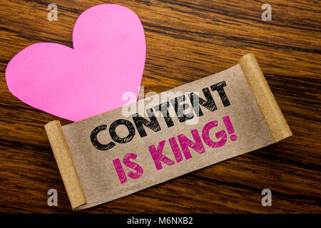 Writing text showing Content Is King. Business concept for Online Internet Data written on sticky note paper, wooden background. With pink heart meani Stock Photo