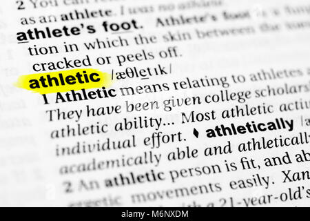 Highlighted English word 'athletic' and its definition in the dictionary. Stock Photo