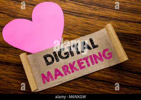 Writing text showing Digital Marketing. Business concept for internet, online, written on sticky note paper, wooden background. With pink heart meanin Stock Photo