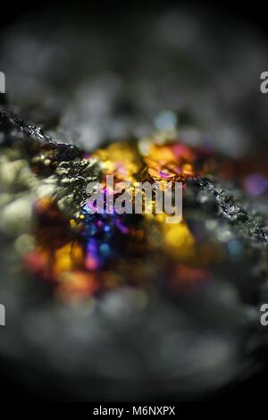 This is iridescent colorful copper ore called peacock ore or chalcopyrite from Virtasalmi copper mine in Finland.  Microscope image. Stock Photo