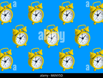 Seamless pattern made of golden analogue clocks in isolated blue background. Stock Photo