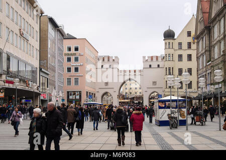 Busy street scene on pedestrianised shopping precinct in old town city centre at Karlstor gate on Neuhauser Strasse, Karlsplatz, Munich, Germany Stock Photo