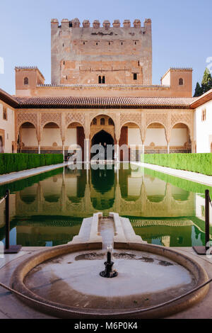 Granada, Andalusia, Spain - July 18th, 2010 : Tower of Comares and reflecting pool in the Court of the Myrtles (Patio de los Arrayanes) of the Comares Stock Photo